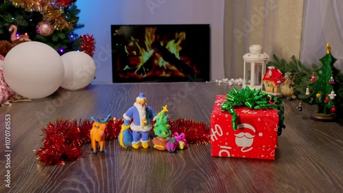 Plasticine handmade child toys. Christmas and New Year Gift Under the Tree with Garland and Ornaments. Festive Fireplace with Christmas Decor Creating a Cozy Holiday Atmosphere.