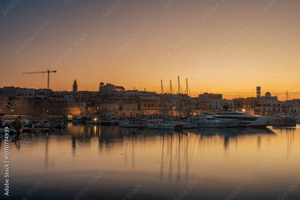 View of seafront, port and the old town Bisceglie in Puglia on sunset. View of seafront, port and the old town Bisceglie in Puglia on sunset.
