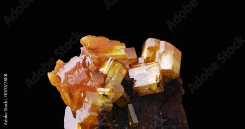 Mimetite crystals rotating footage. isolated on black background. Specimen from Pingtouling Mine, China. macro detail close-up mineral crystal unpolished semi-precious gemstone. photo