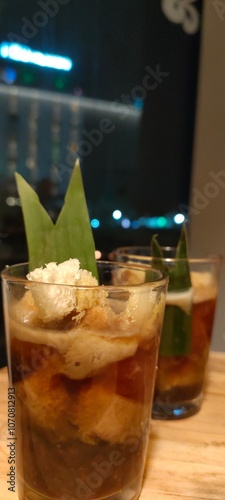 two glasses of a refreshing beverage, likely a traditional Indonesian drink called Es Kelapa Muda. photo