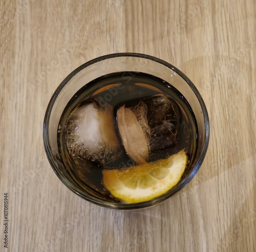 Chilled Glass of Cola with Ice and Lemon Slice photo
