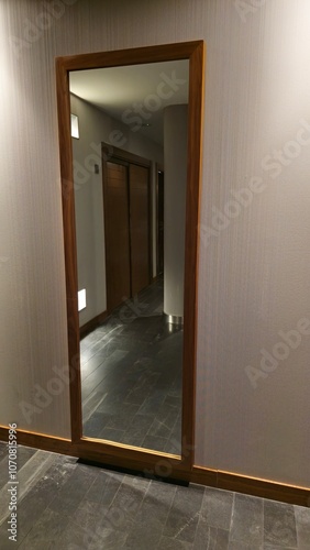 Modern Hallway Reflected in a Large Wooden-Framed Mirror photo