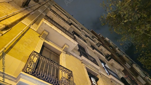 Looking Up at a City Building Facade at Night photo