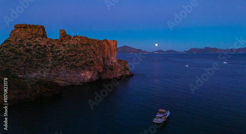 Early hours of a full moon night in the sea of San Carlos Sonora. The rocky cliffs full of desert sahuaros frame the serene sea of this Mexican tourist destination.


 photo