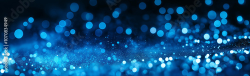 Digital blue glow particle abstract bokeh background with shine and glow blue light balls