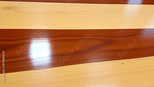 A close up of high gloss lacquered wood paneling with a deep rich brown color the reflective surf.deep brow wood planks with natural texture, wooden retro background, light wooden background, table