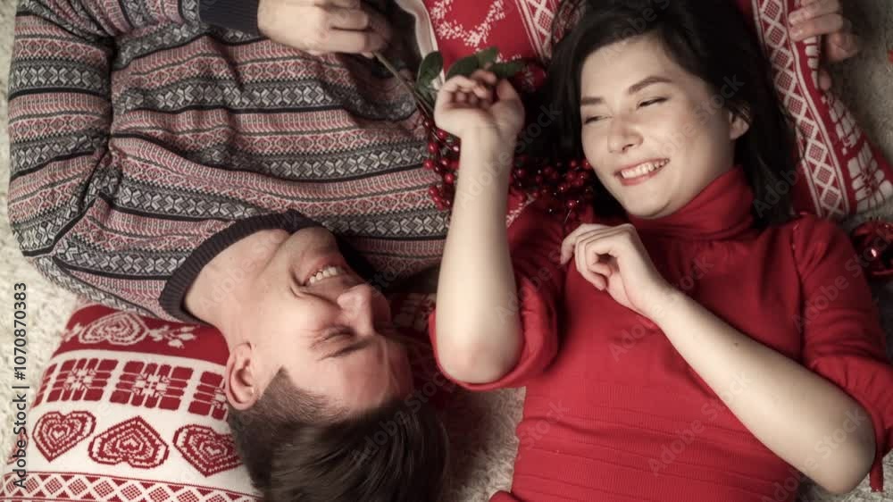 Happy couple in love enjoying xmas and lying head to head. Top view. Relationship, family, christmas, new year, holiday concet.