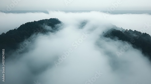 A misty morning over a mountain range with a layer of clouds creating a sea of white.