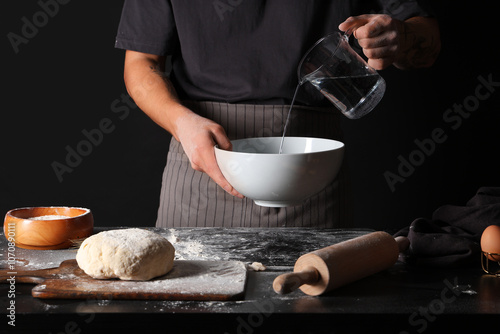 Man preparing fresh dough o...