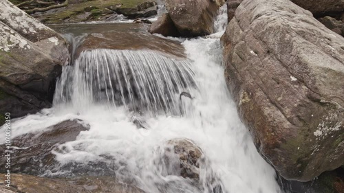 A closeup panning shot of rapids along Paine Creek in the Laurel Snow State Natural Area, with ambient sound.