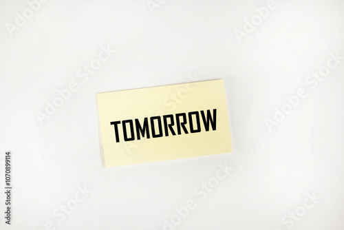 The inscription "tomorrow" on a yellow sticker with a white background