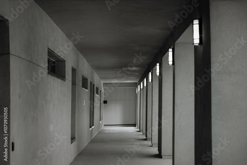 Long grey empty exterior hallway in building overhang, concrete, nobody