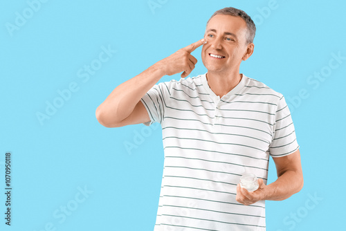 Happy mature man applying c...