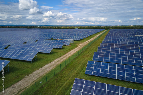 Aerial view of large sustainable electrical power plant with rows of solar photovoltaic panels for producing clean electric energy. Concept of renewable electricity with zero emission
