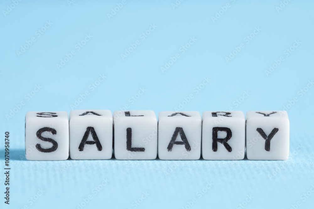 Word Salary made of cubes on light blue background Word Salary made of cubes on light blue background