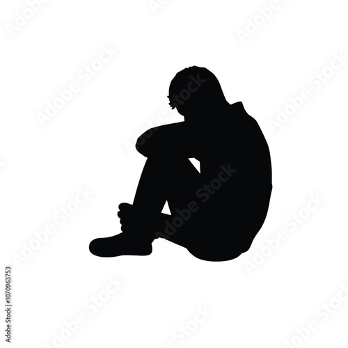a black silhouette of a person sitting on the ground. The person is sitting with their legs crossed and their head resting on their knees