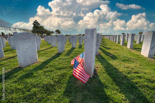 Military burial headstones. Sarasota National Cemetery with rows of white tomb stones and USA flags on green grass. Memorial Day concept photo