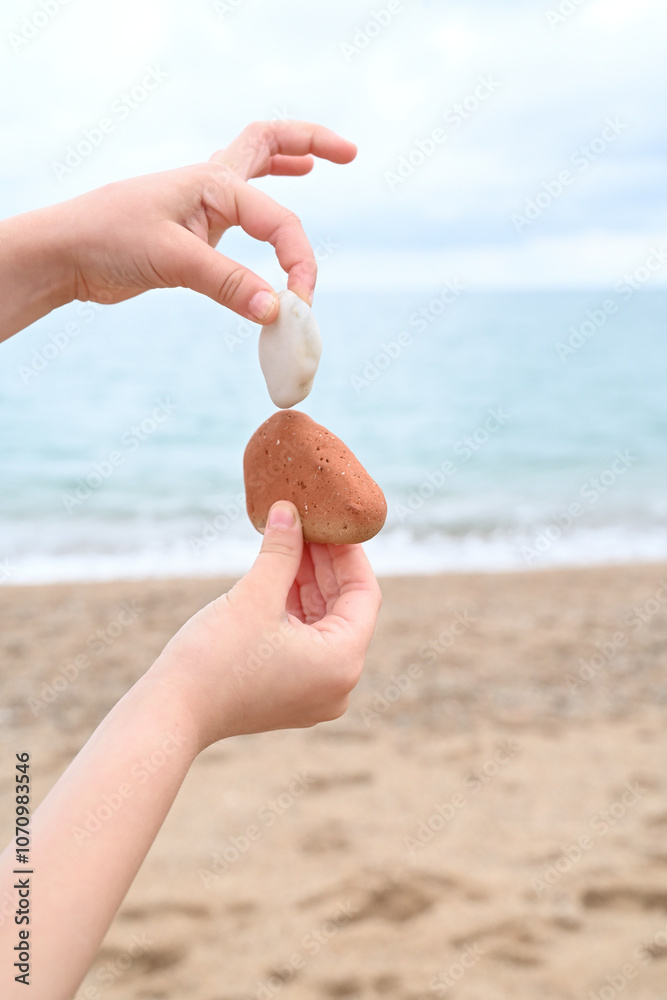 Young Girl Gathering Rocks by the Ocean Young Girl Gathering Rocks by the Ocean