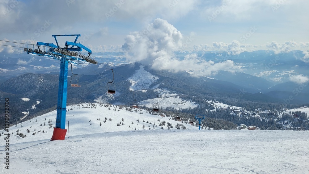 winter mountain landscape with ski resort. View of the ski lift on the top of the mountain winter mountain landscape with ski resort. View of the ski lift on the top of the mountain