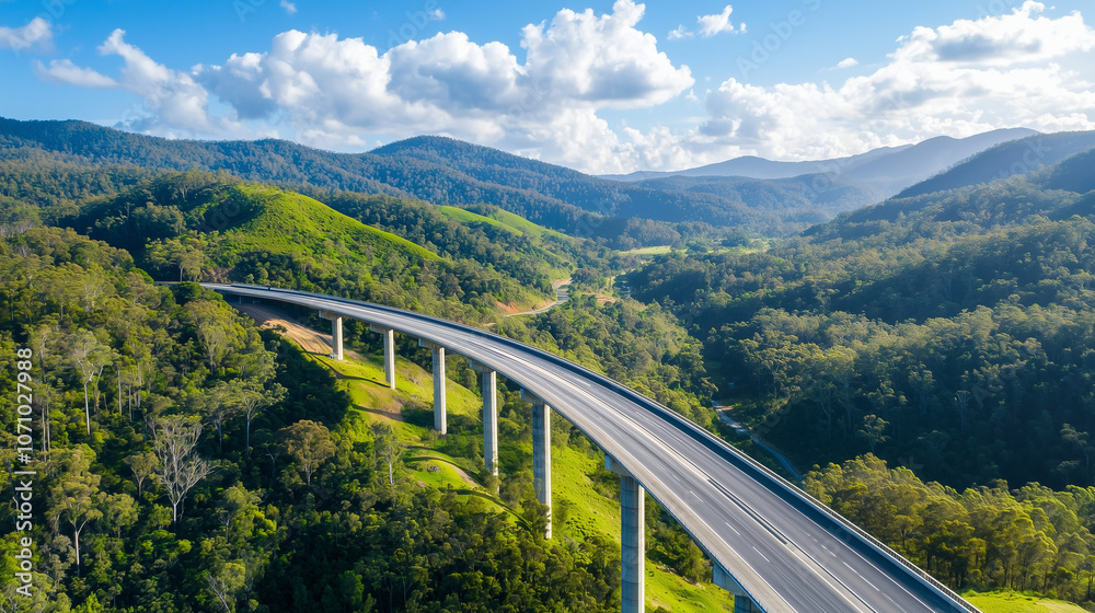 Modern Highway Bridge Over Lush Green Valley and Forested Hills Modern Highway Bridge Over Lush Green Valley and Forested Hills