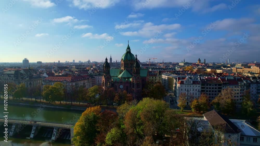 4K Aerial Drone video of beautiful autumn in city center Munich with Isar river, Saint Lukas church, Marienplatz and Maximilianeum on a sunny warm day, Germany