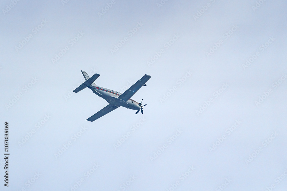 A plane with a propeller flies high in the sky. A plane with a propeller flies high in the sky.
