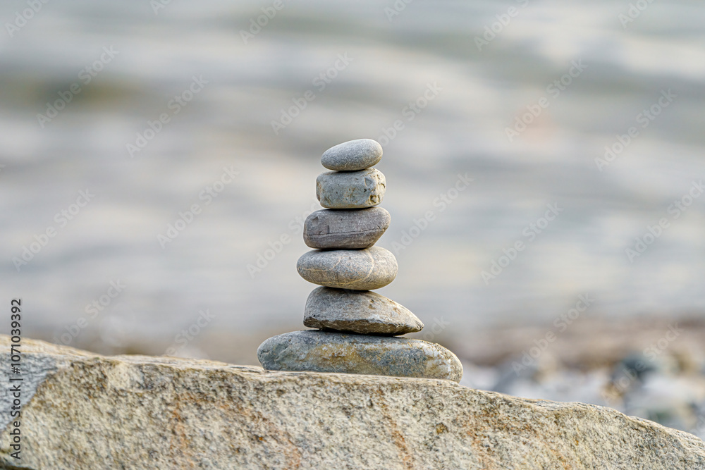 Fototapeta premium Balancing zen stones on top of each other in the background