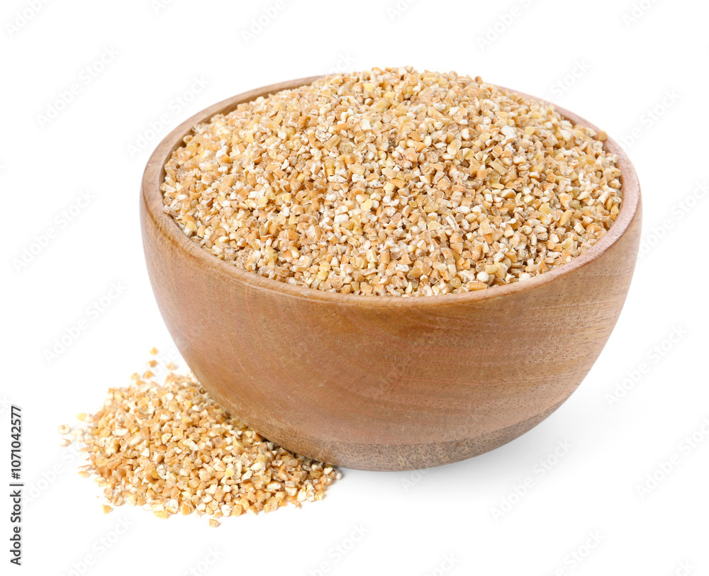 Dry wheat groats in wooden bowl isolated on white Dry wheat groats in wooden bowl isolated on white