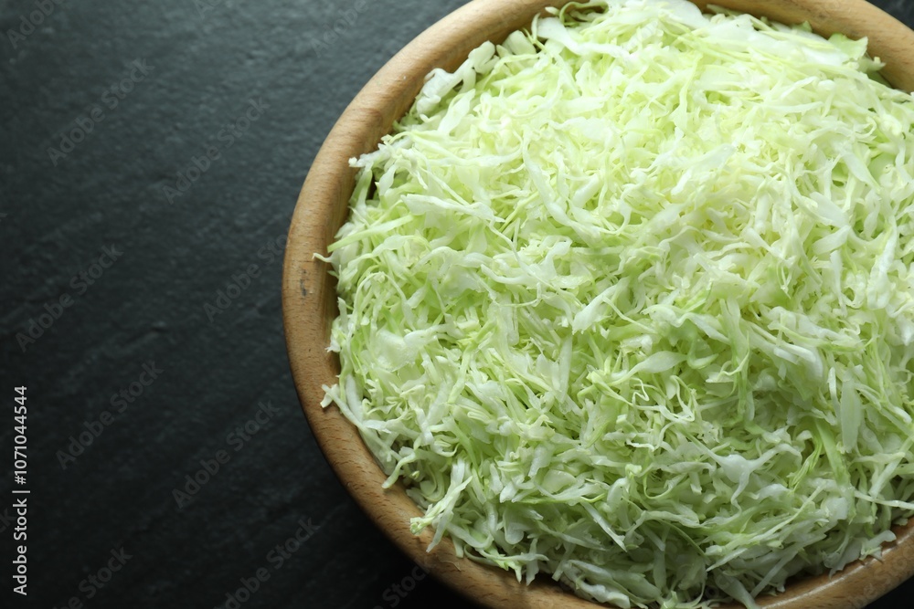 Fresh shredded cabbage on black table, top view Fresh shredded cabbage on black table, top view