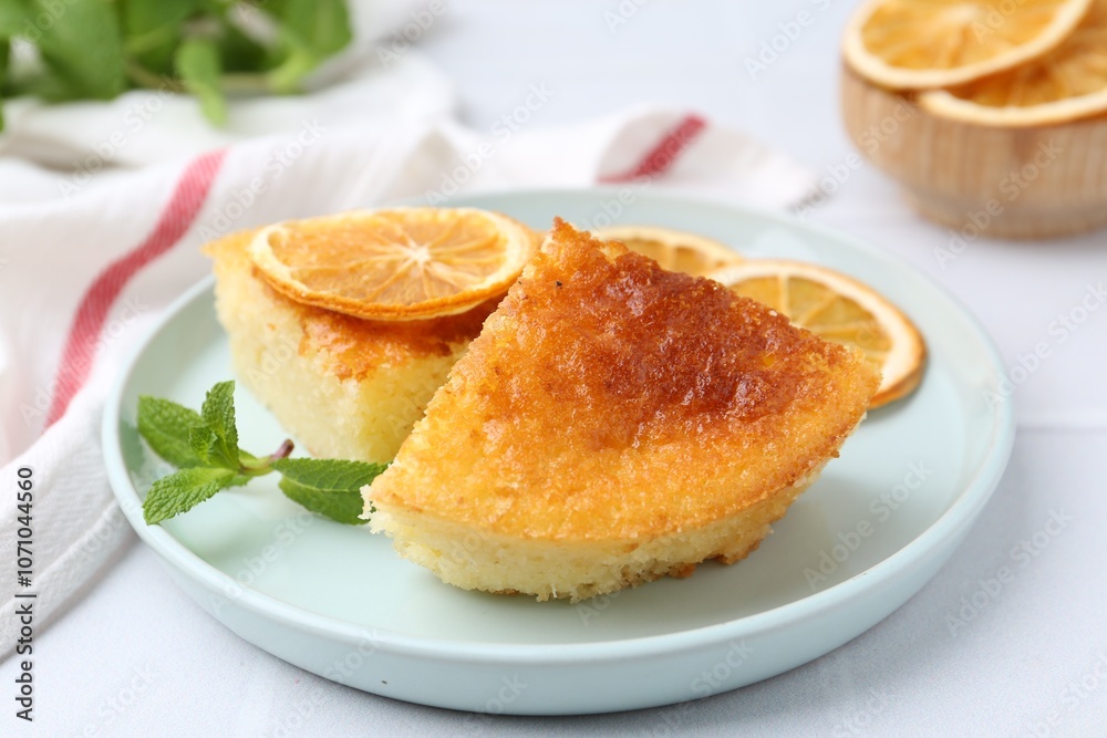 Tasty semolina cake served on white tiled table, closeup Tasty semolina cake served on white tiled table, closeup