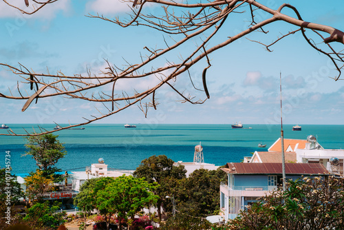 Vung Tau Beach with Blue Sky Flowers and Mother Mary Statue Scenic Coastal View with Coffee Shop Nearby High quality photo