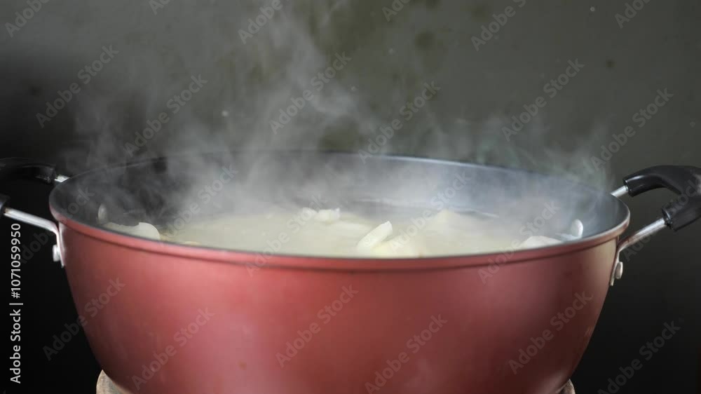 Boiling cassava in hot pot on stove Boiling cassava in hot pot on stove