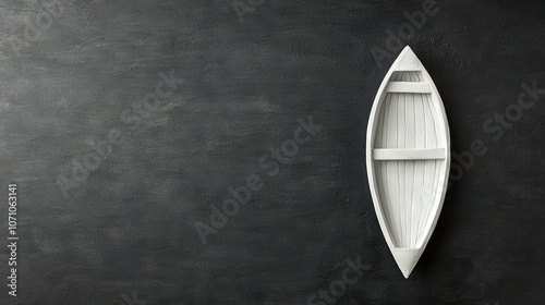  A white boat rests atop a black wall, beside a white shelf featuring a rowboat