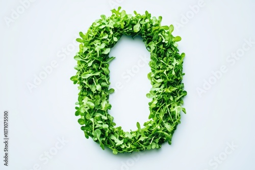 Zero is formed from fresh green arugula sprouts on a light backdrop
