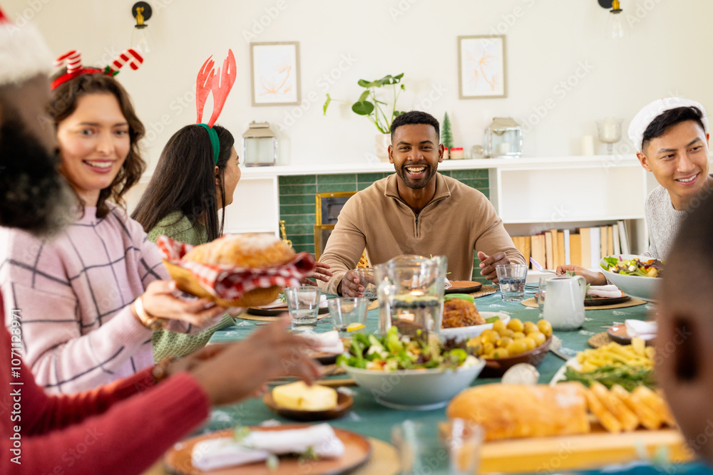 Diverse multiracial family enjoying festive christmas meal together, at home Diverse multiracial family enjoying festive christmas meal together, at home