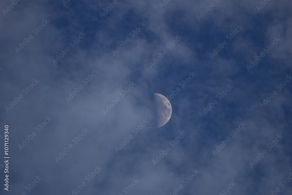 Moon in the blue sky with white clouds, closeup of photo Moon in the blue sky with white clouds, closeup of photo