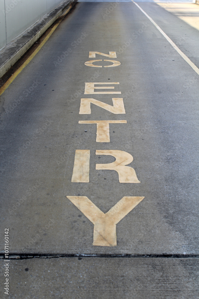 Fototapeta premium Yellow No Entry sign painted on a concrete asphalt bitumen road