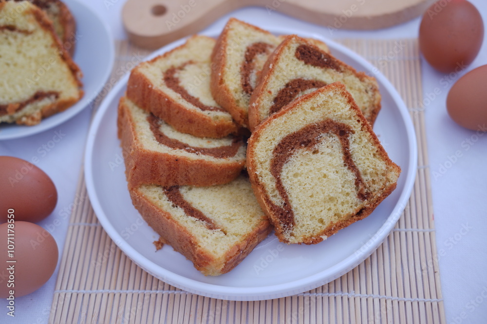 sponge cake on a white plate with beautiful decoration sponge cake on a white plate with beautiful decoration