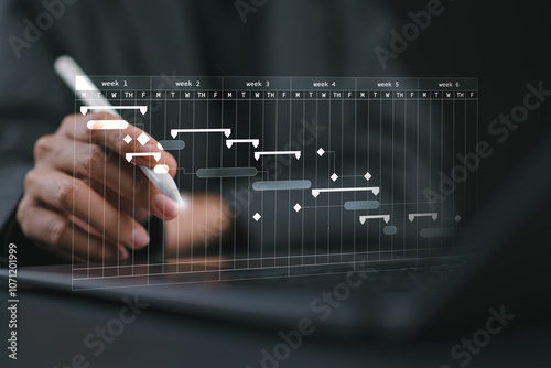 Project management concept. Site manager working with Gantt chart schedule to plan tasks and progress. Planning software. Corporate strategy for construction, finance, operations, sales, marketing.