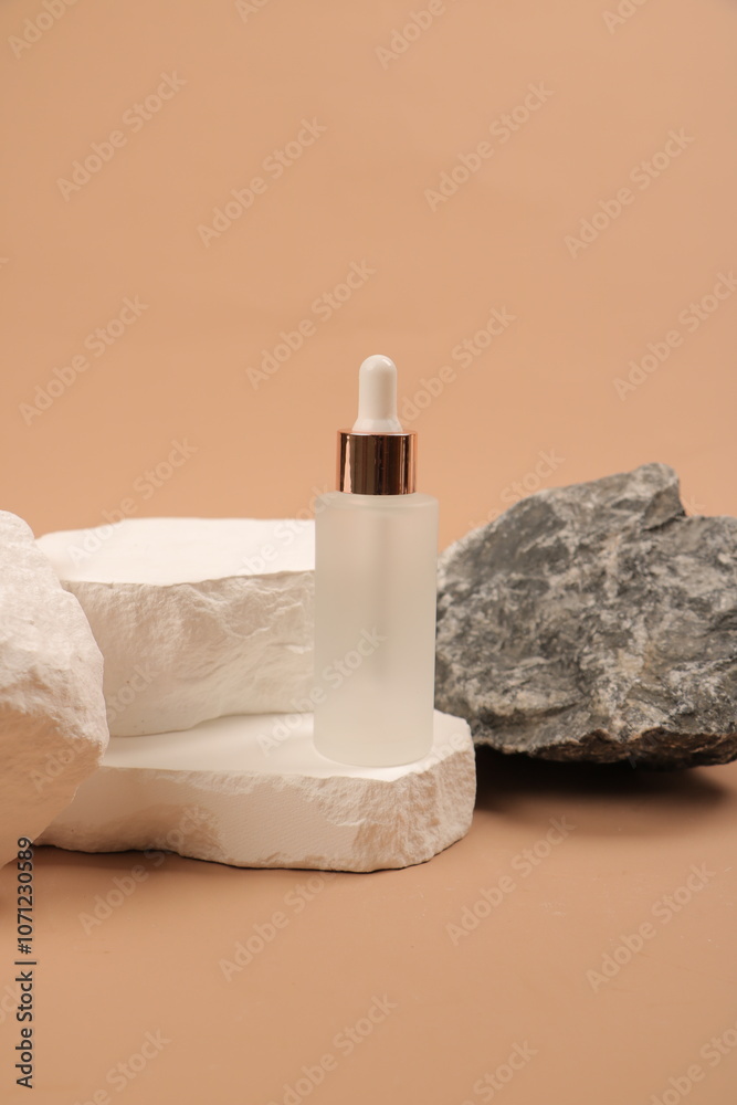 Frosted Glass Serum Dropper Bottle with Green Leaves and Stone Background Frosted Glass Serum Dropper Bottle with Green Leaves and Stone Background