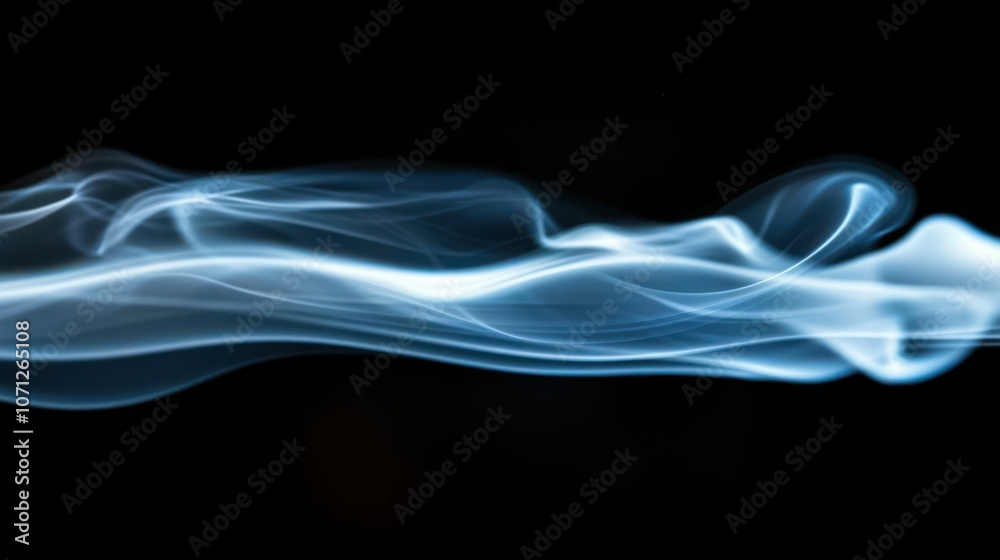 Blue smoke rising in soft, ethereal tendrils against a black background. Blue smoke rising in soft, ethereal tendrils against a black background.