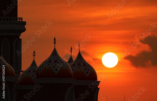 99 dome mosque and sun at dusk
