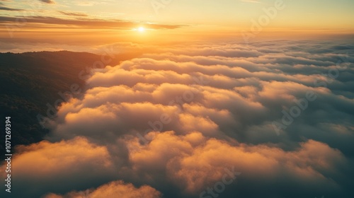 A serene sunrise over a sea of clouds, creating a tranquil and picturesque landscape.