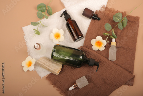 Natural Skincare Bottles and Glass Droppers with Floral and Herbal Elements photo