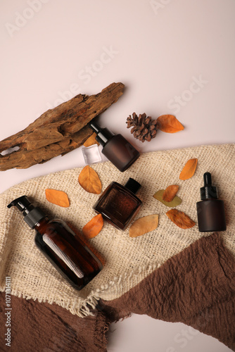 Autumn Themed Amber Glass Dropper Bottles with Warm Natural Decor for Skincare and Essential Oils photo