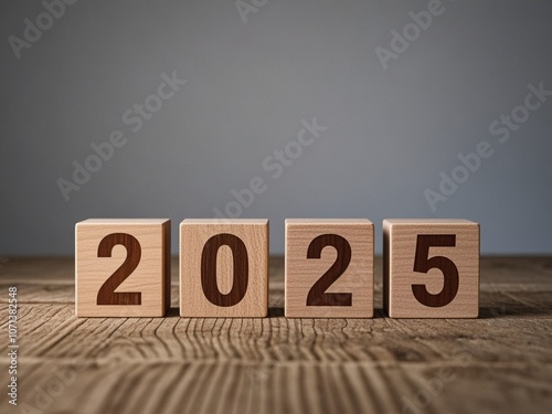 Obraz na płótnie Wooden Blocks Displaying the Year 2025 on Wooden Surface with Gray Background w salonie