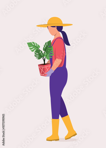 Side View Of A Young Woman With Hat, Rubber Boot And Glove Carrying A Potted Plant.