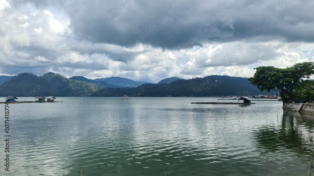 Serene Lake with Cloudy Sky and Green Hills Serene Lake with Cloudy Sky and Green Hills