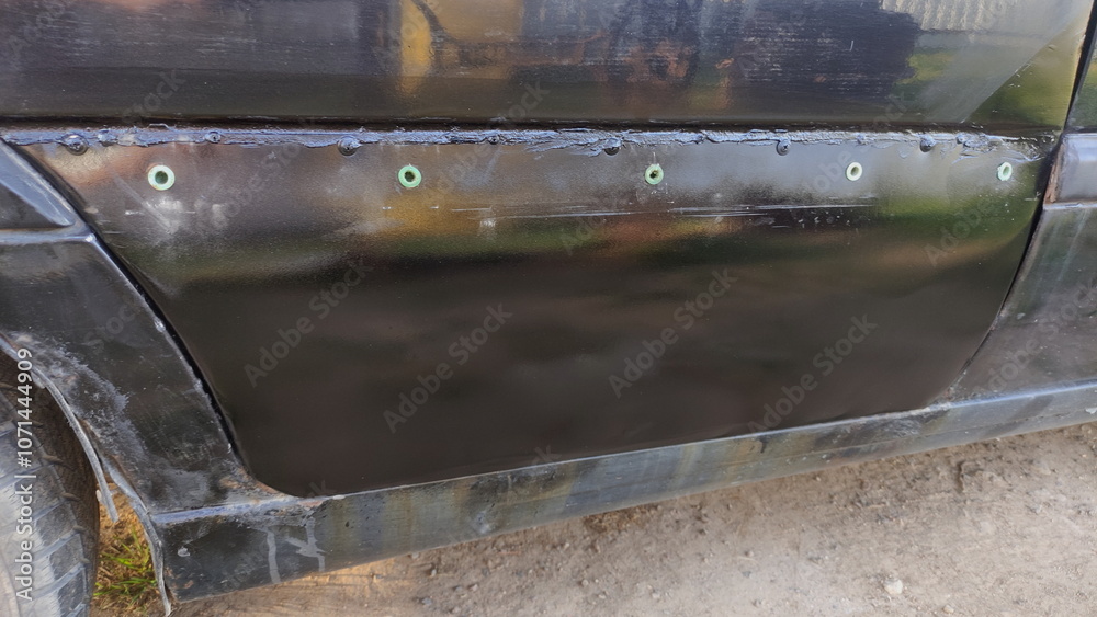 Rusty car body door quick repair with a painted zinc galvanized metal sheet
