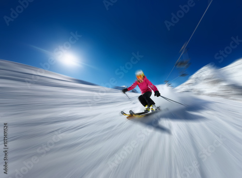 A skier in a pink jacket carves down a snowy slope with a bright blue sky and a chairlift in the background. photo